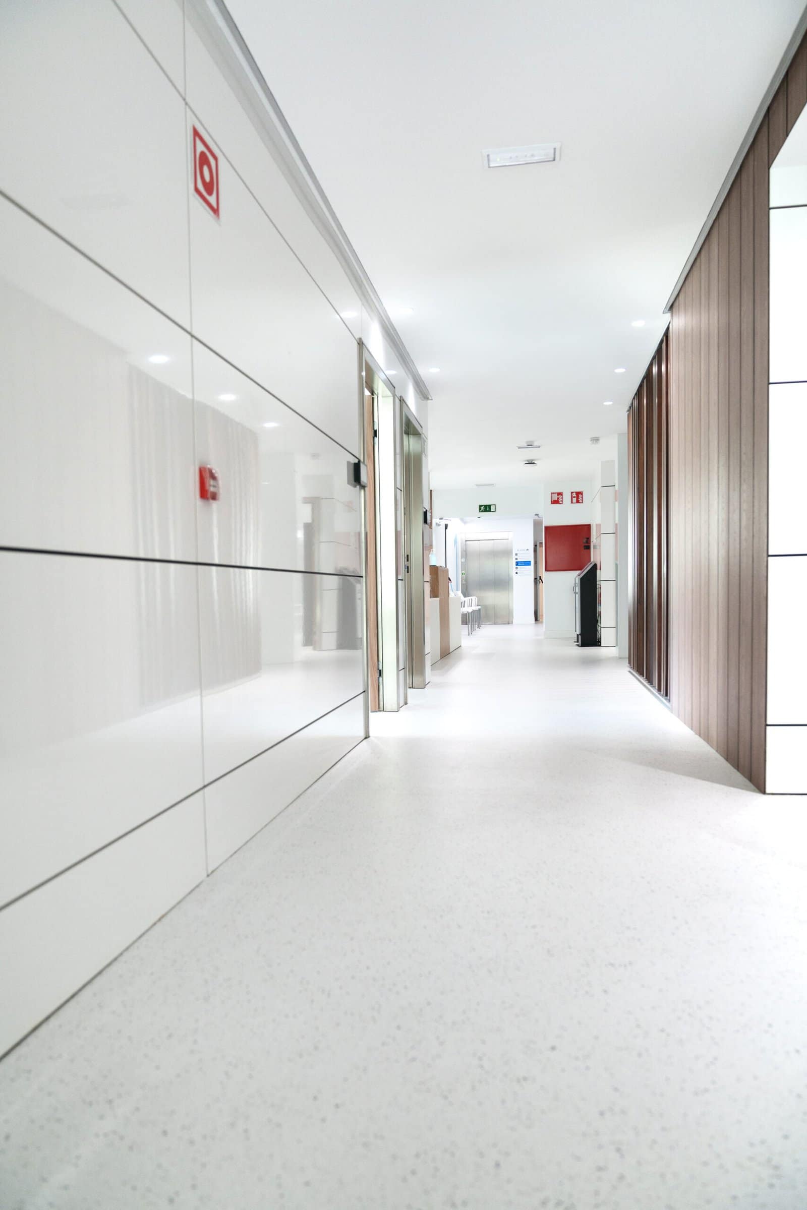 Bright and sterile hospital corridor with visible emergency