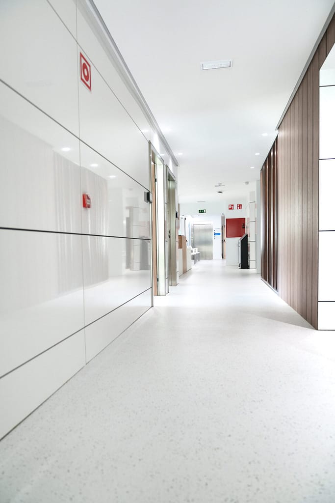 Bright and sterile hospital corridor with visible emergency